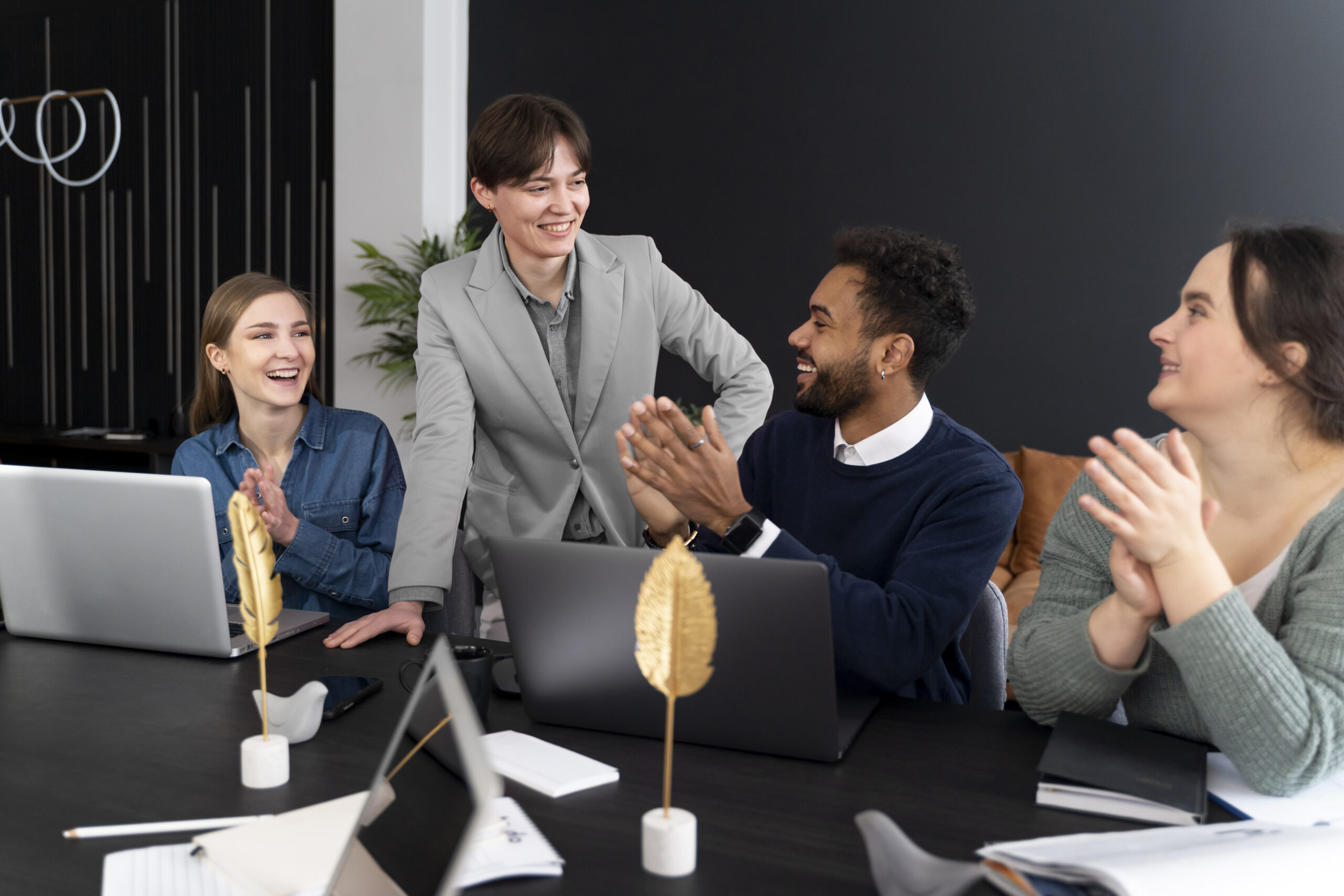 trans person working office with colleagues
